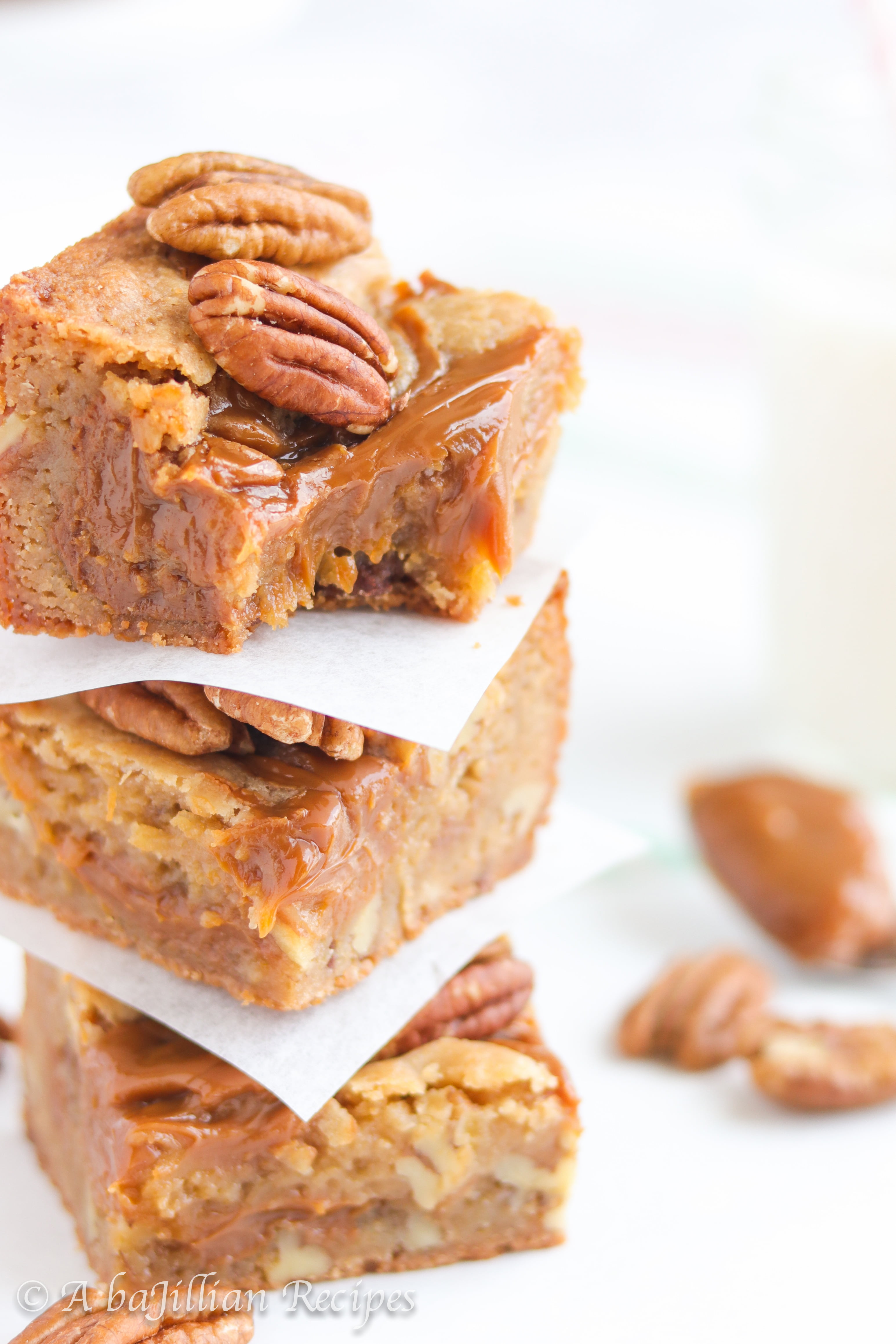 Thick and chewy brown butter blondies packed with pecans and ooey gooey pockets of dulce de leche!
