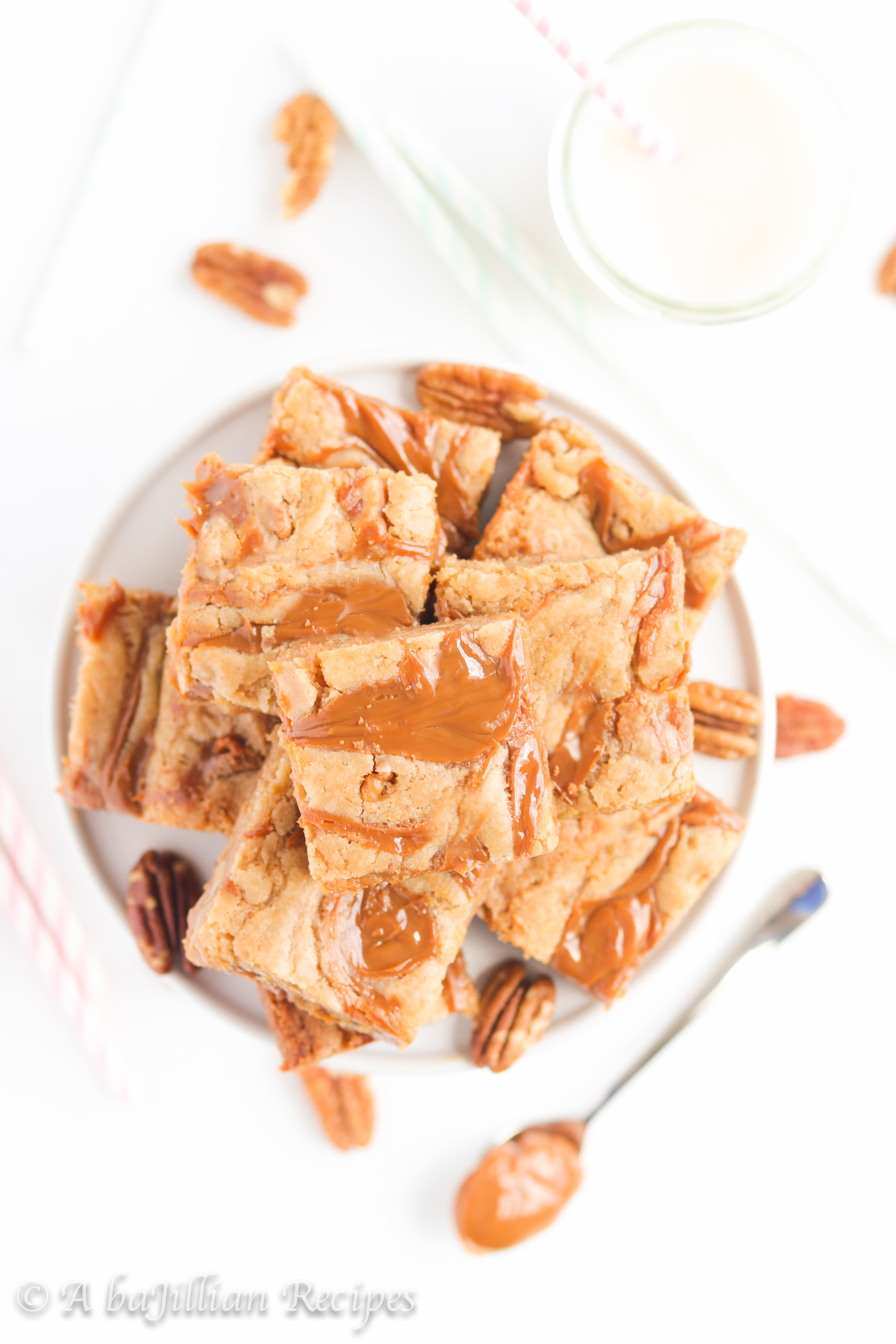 Thick and chewy brown butter blondies packed with pecans and ooey gooey pockets of dulce de leche!