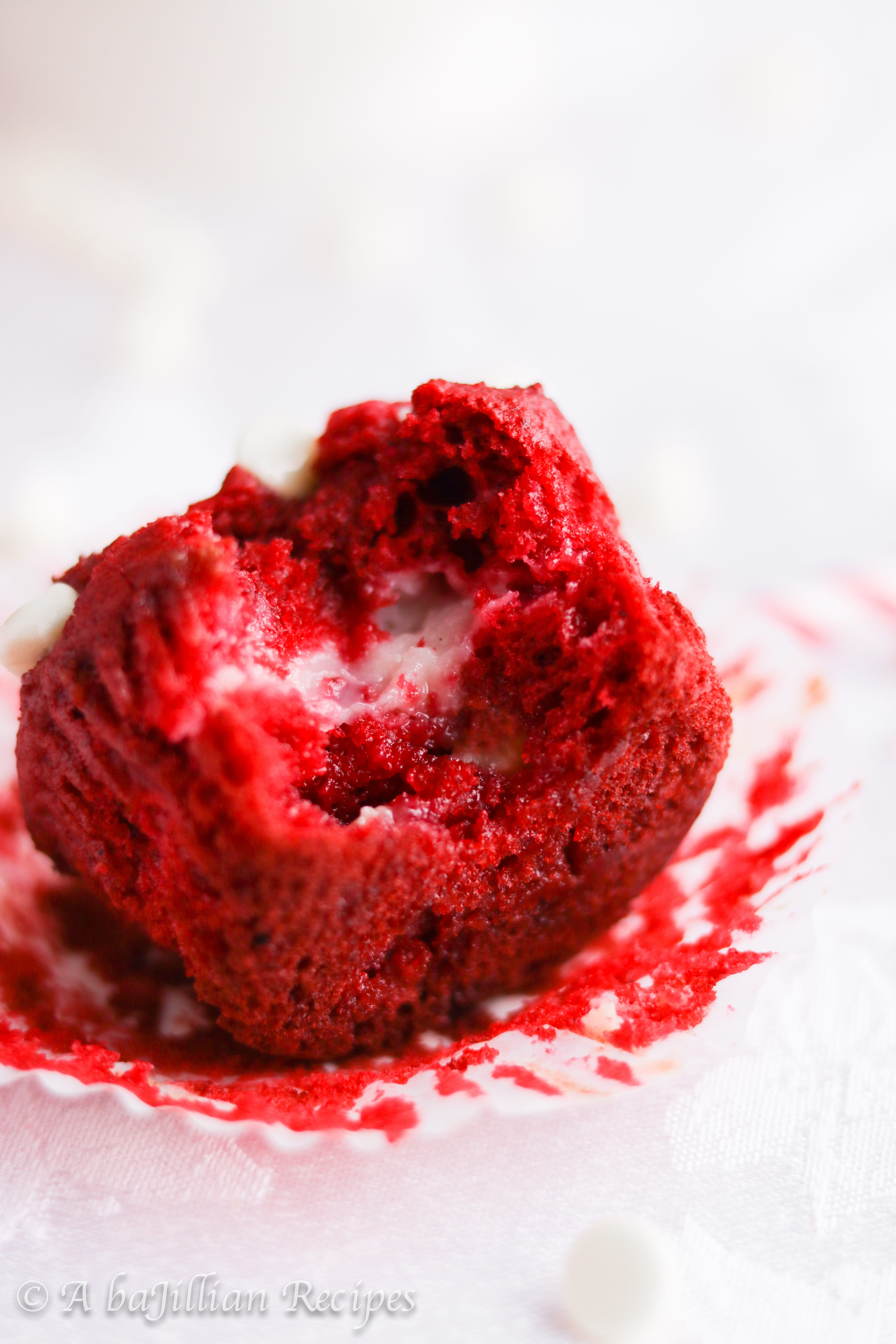 Moist and fluffy red velvet muffins loaded with white chocolate chips and filled with a sweetened cream cheese center!