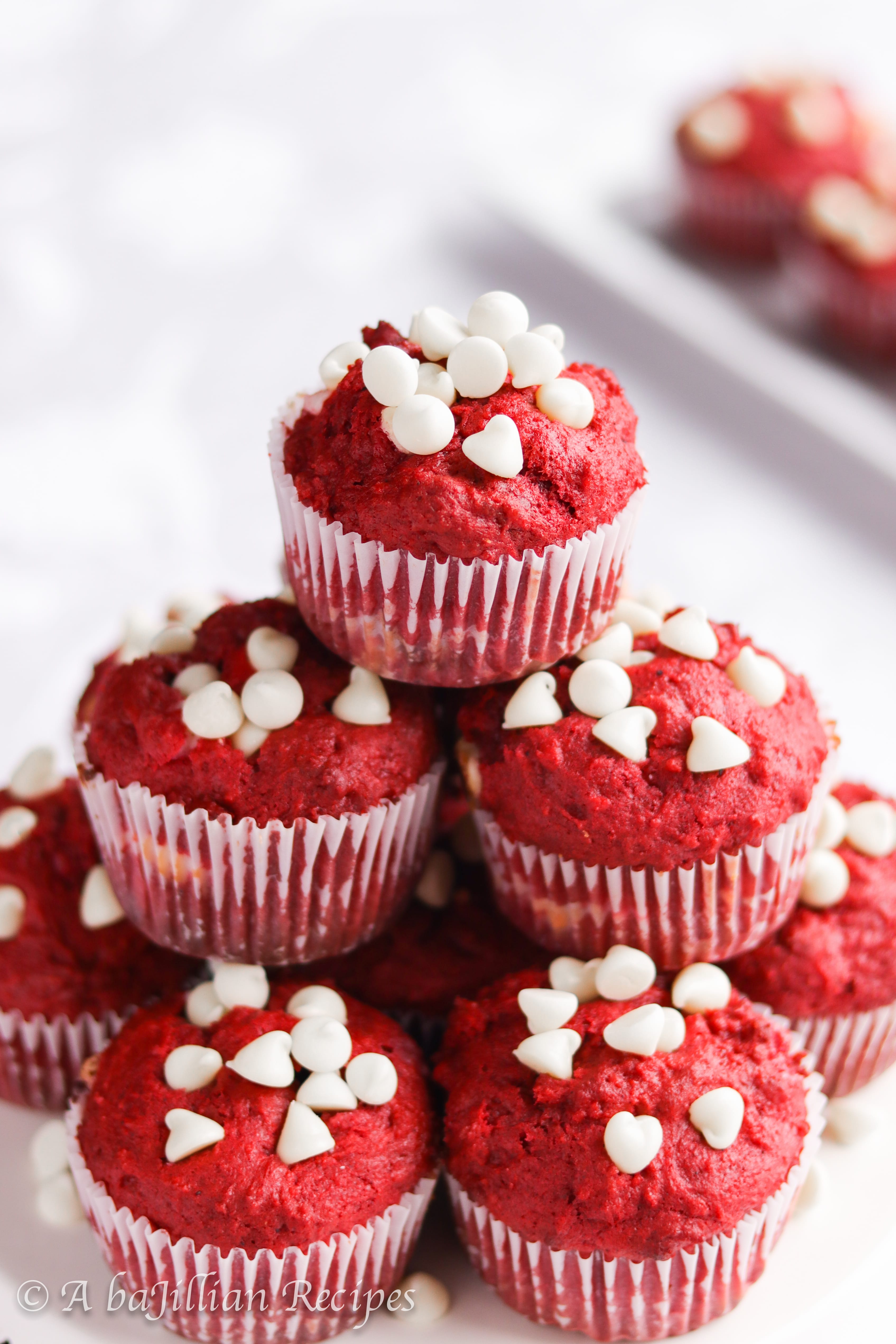 Moist and fluffy red velvet muffins loaded with white chocolate chips and filled with a sweetened cream cheese center!