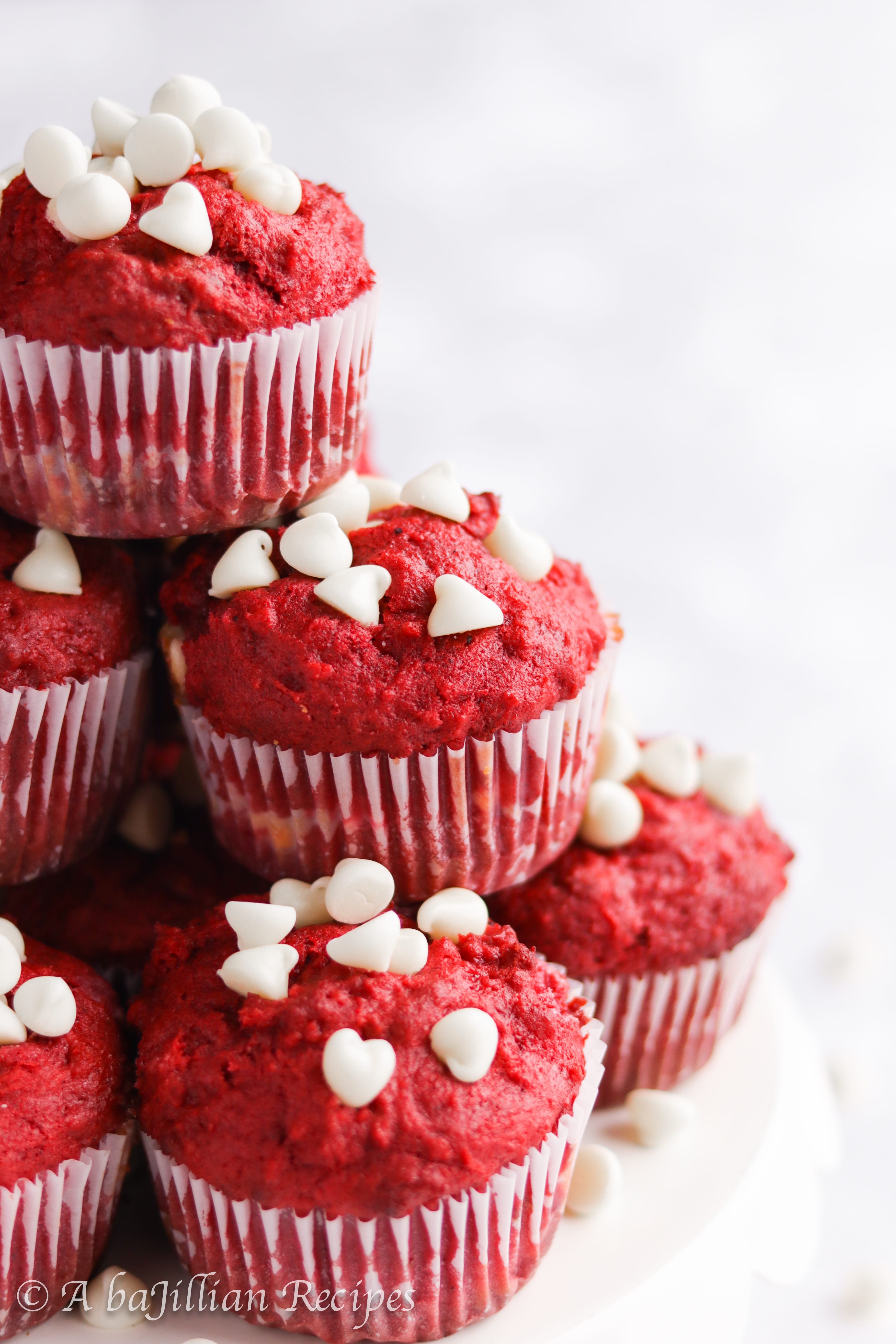 Moist and fluffy red velvet muffins loaded with white chocolate chips and filled with a sweetened cream cheese center!